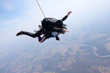 Skydiving. Tandem jump. Man and woman in the sky.