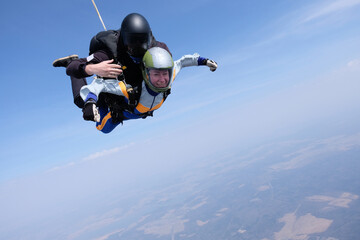 Skydiving. Tandem jump. Man and woman in the sky.