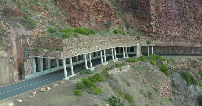 Aerial view. Chapmans Peak Drive near Cape Town, South Africa. Top view of road going through beautiful landscape. Road bending along the ocean.