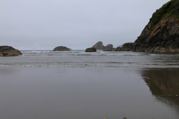 large cliff in oregon state bordering california state on pacific ocean on a cloudy day 