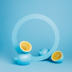Product podium and frame for copy space with blue lemons on blue background. Concept scene stage...
