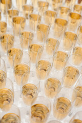 Obraz na płótnie Canvas Champagne in bottles and in many glasses