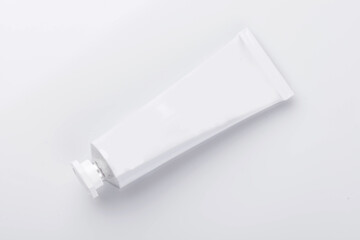 Top view of open blank cosmetic tube isolated on white