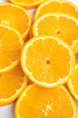 Orange vitamin bomb. Heap of stacked orange slices. Perfectly sliced oranges. Juicy orange pieces. Vertical image