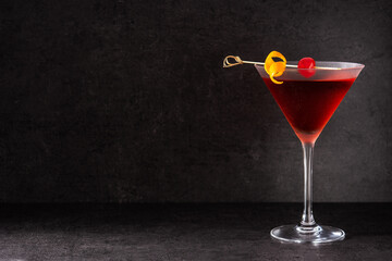 Traditional Manhattan cocktail with cherry on black background.Copy space