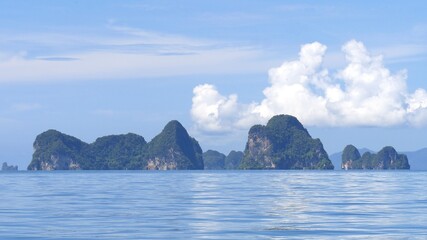 Exotic scenery islands with cloudscape and calm waters of Andaman sea in Krabi Province, Thailand.