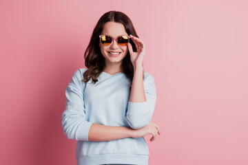 Photo of pretty confident lady beaming smile look camera in sunglass on pink background