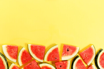Sliced watermelon on yellow background, top view
