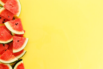 Sliced watermelon on yellow background, top view