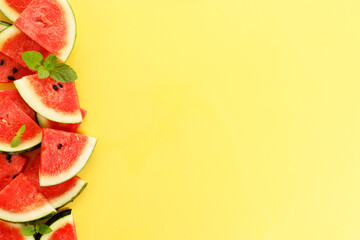 Sliced watermelon on yellow background, top view