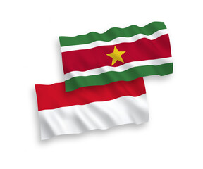 National vector fabric wave flags of Indonesia and Republic of Suriname isolated on white background. 1 to 2 proportion.