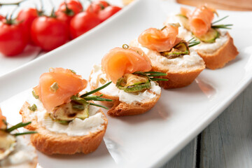 Deliziosi crostini con crema di formaggio, zucchine e salmone affumicato, Antipasti italiani 