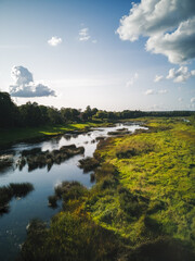 Sky,clouds,river and green landscape.