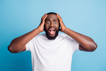 Photo of speechless loser young man open mouth hands head wear white t-shirt over blue background