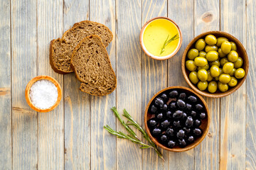 Italian food background with olives oil and sliced bread. Top view