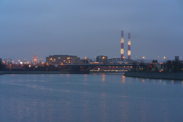 Moscow cityscape and Moscva river in blue colors at evening  spring time. Dull sunset, rain.