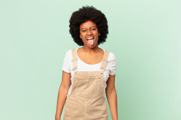 afro woman with cheerful, carefree, rebellious attitude, joking and sticking tongue out, having fun...