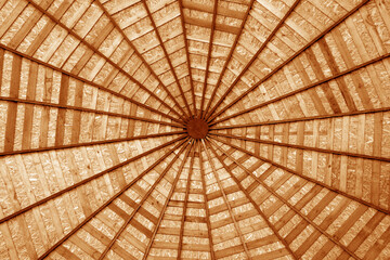 Wooden roof from bottom in orange tone.
