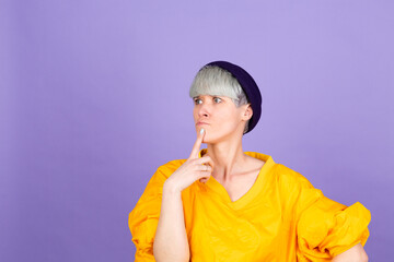 Stylish european woman on purple  background thinking worried looking aside concerned