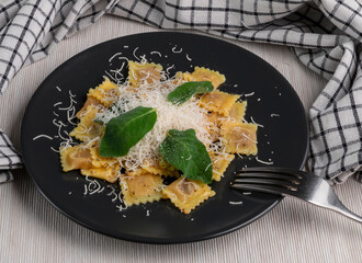 A delicious dish of small ravioli stuffed with meat topped with butter, sage leaves and grated parmesan, a typical Italian dish