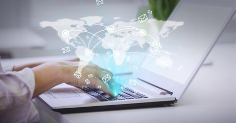 Composition of world map and digital icons over woman using laptop in office