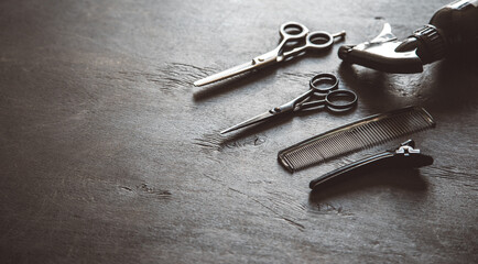 Set of professional hairdresser tools with combs and styling on dark wooden background top view mock up.