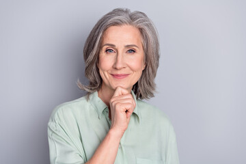 Photo of happy good mood lovely beautiful mature woman smiling thinking brainstorming isolated on grey color background