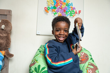 Child holding up his book