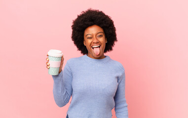 afro woman with cheerful, carefree, rebellious attitude, joking and sticking tongue out, having...