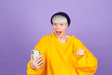 Excited young woman amazed by unbelievable shopping mobile app sale message looking at smartphone, girl winner holding cell phone screaming with joy