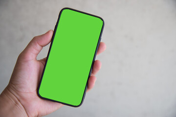 Hand with smartphone green screen.