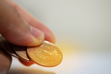 Hand with coins in saving money.