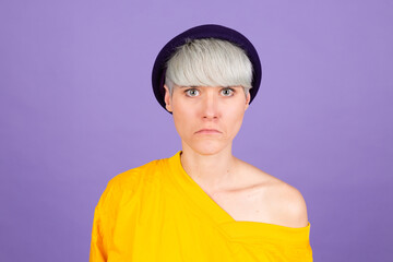 Stylish european woman on purple background sad upset unhappy emotions