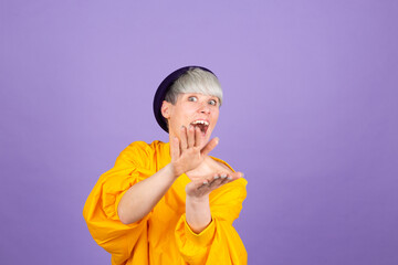 Stylish european woman on purple background clapping and applauding happy and joyful, smiling proud hands together