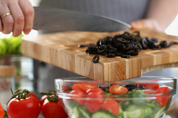 Man chooses food in vegetable salad closeup