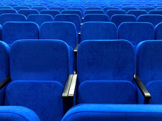 Obraz premium Blue chairs in an empty concert hall. Empty rows in the cinema.