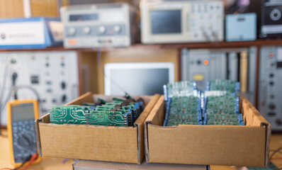 Close-up green embedded microcircuits are stacked in box to prepare for the further in factory for...