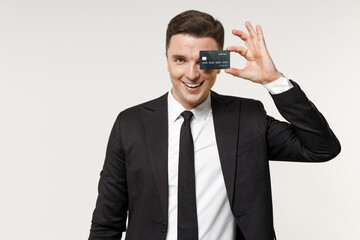 Young cheerful successful rich employee business corporate lawyer man in classic formal black grey suit shirt tie work in office cover eye with credit bank card smiling isolated on white background.