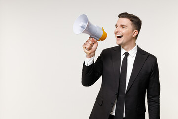 Young employee business corporate lawyer man 20s wearing classic formal black grey suit shirt tie work in office scream aside hot news shout in megaphone isolated on white background studio portrait.