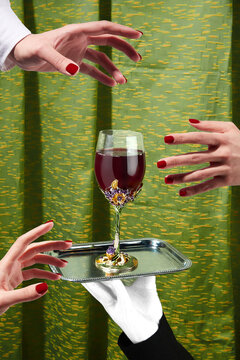 Hand In White Glove Is Holding Steel Tray With Fine Crystal Wine Glass Decorated With Metal Fantasy Flowers And Crystals. Three Female Hands Are Reaching For The Glass With Red Drink. 