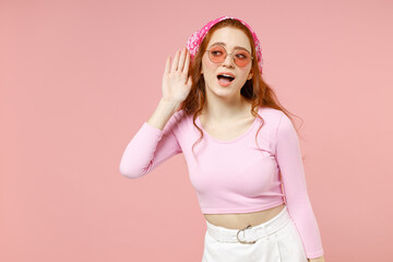 Young curious nosy caucasian woman 20s wear rose clothes bandana glasses try to hear you overhear...