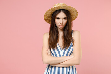 Young frowning sad serious caucasian angry woman 20s wear summer clothes striped dress straw hat...