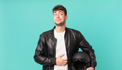 motorbike rider shrugging, feeling confused and uncertain, doubting with arms crossed and puzzled...