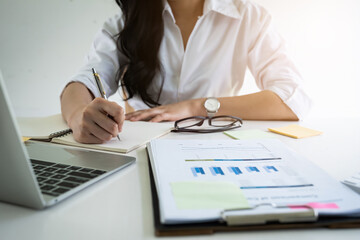 Business woman hand holding pen and paperwork, account or saving money or insurance concept.