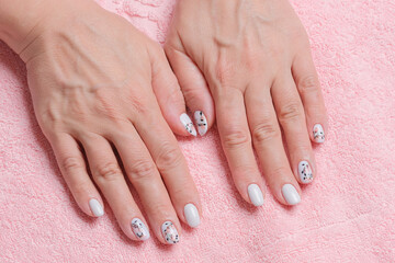 Perfect  fingernails of adult woman. Art painting of nails. Care for sensuality female hands. Shallow depth of field.