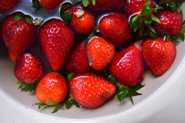 Plate full with strawberries in water