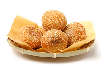 Golden fried dessert balls covered with sesame on white background