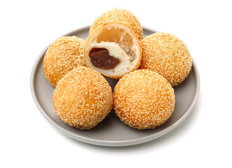 Golden fried dessert balls covered with sesame on white background