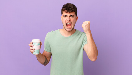 man with coffee shouting aggressively with an angry expression or with fists clenched celebrating...