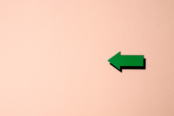 green arrow on pink background